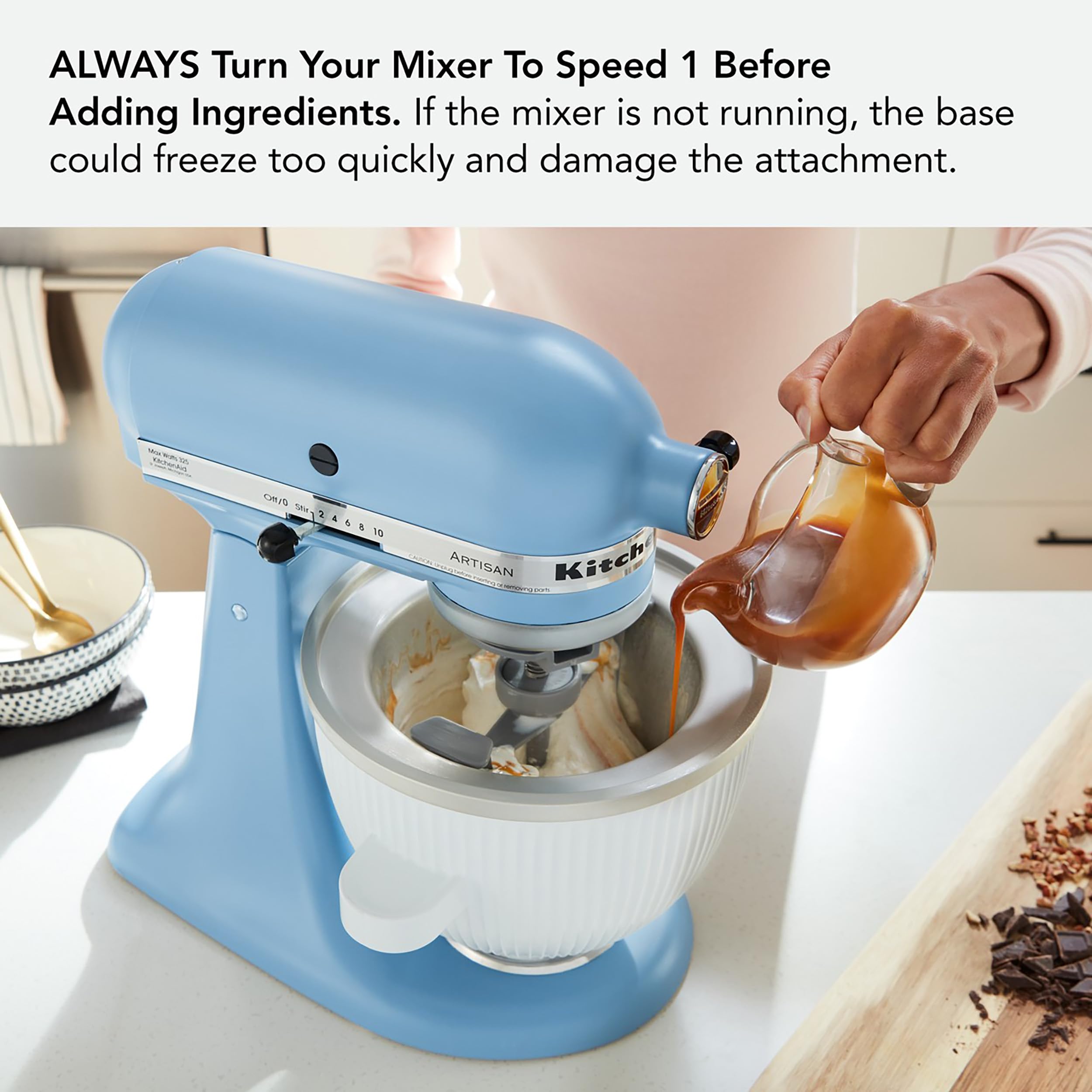 KitchenAid bowl beside measuring cup showing 2-quart capacity scale