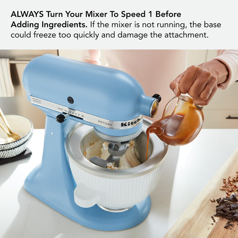 KitchenAid bowl beside measuring cup showing 2-quart capacity scale