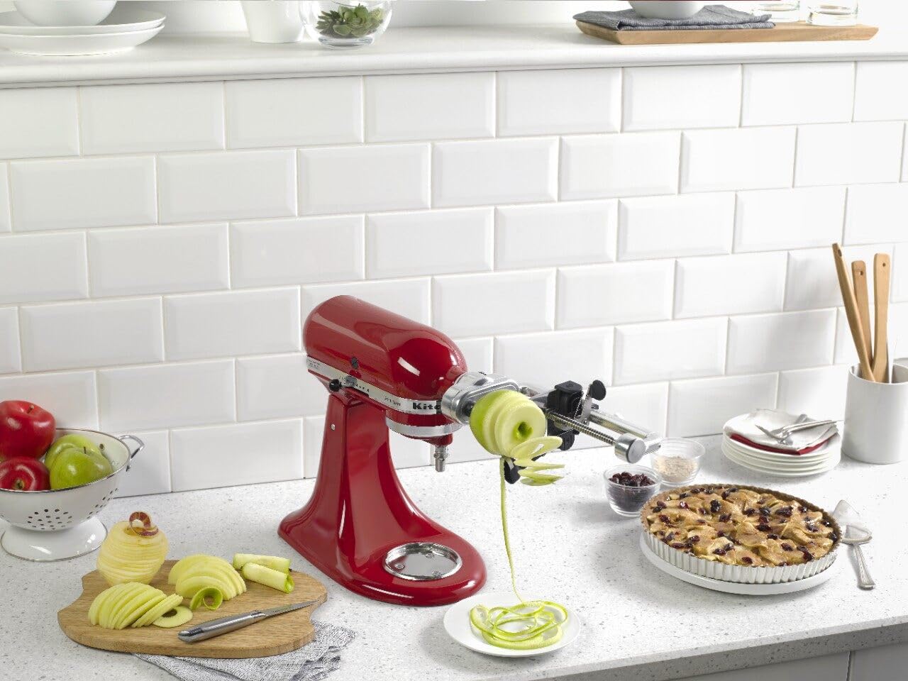 KitchenAid spiralizer attached to stand mixer demonstrating powered spiralizing in use
