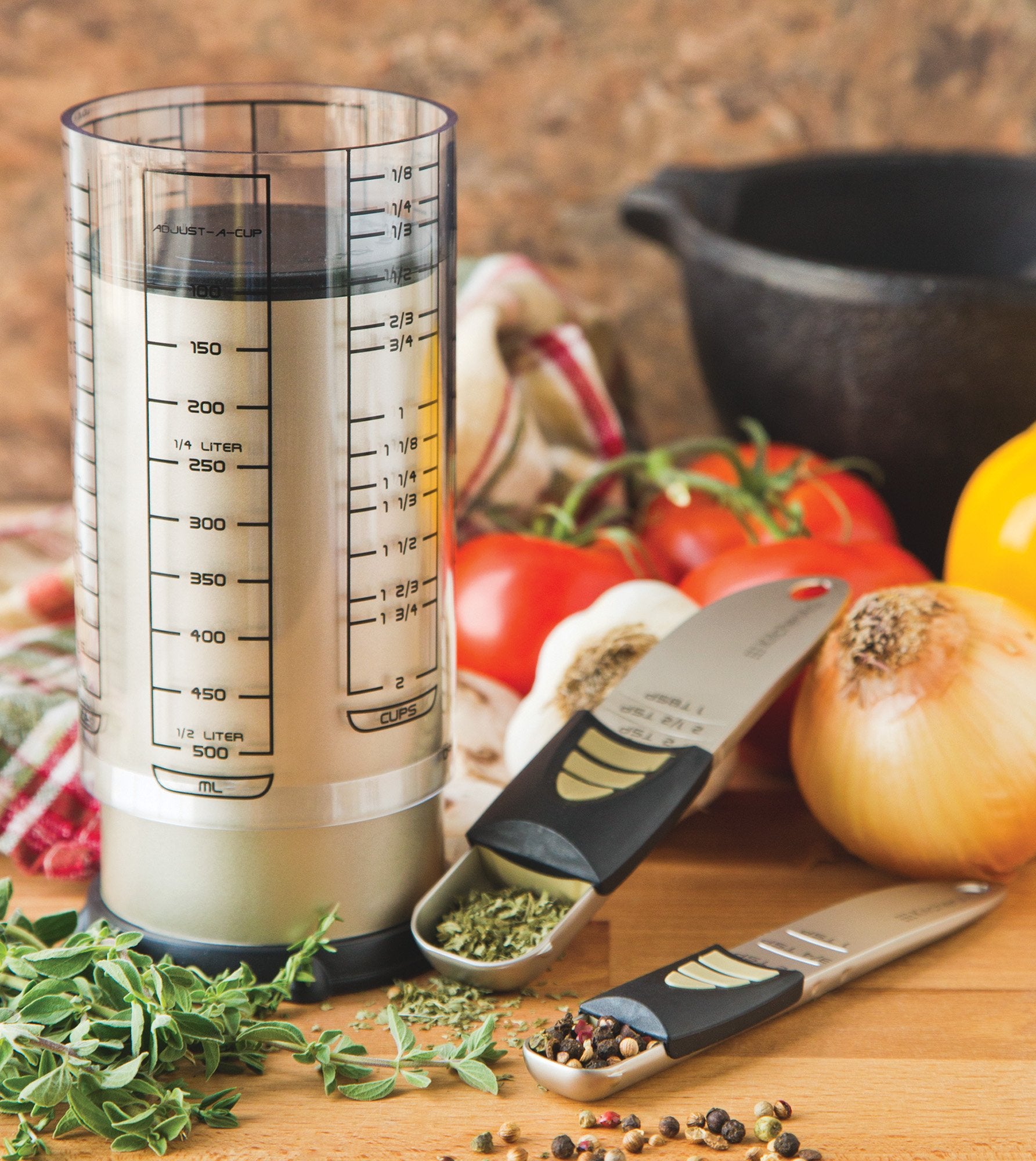 KitchenArt 2-cup Adjust-A-Cup beside standard cup showing space-saving versatility