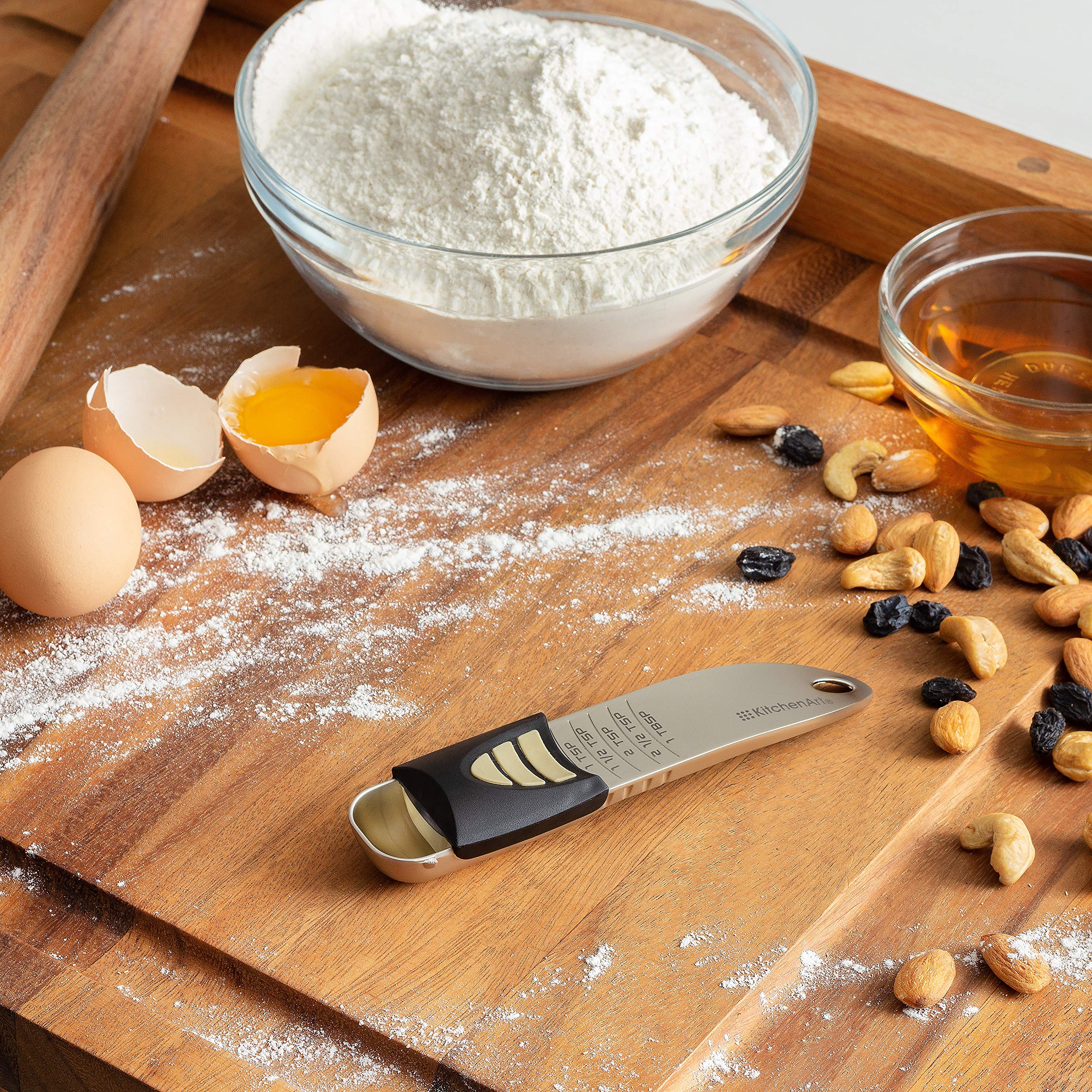 KitchenArt scooping spices with adjustable spoon showing effortless seasoning portioning