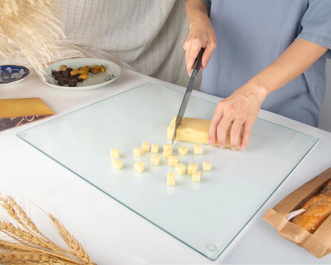 Kitchenville glass board receiving a hot pan to show heat-resistant trivet functionality