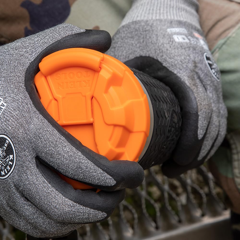 Klein Tools tumbler held in gloved hand demonstrating secure handling benefit
