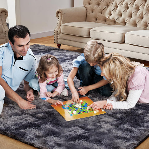 KNZE rug next to chair showing 5x7 scale and space-defining benefit