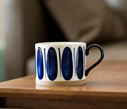 Koja mug pouring coffee demonstrating microwave-safe reheating benefit
