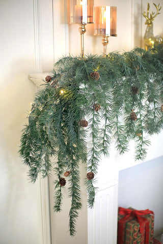 Konosnd garland on porch under cover illustrating weather-ready decor