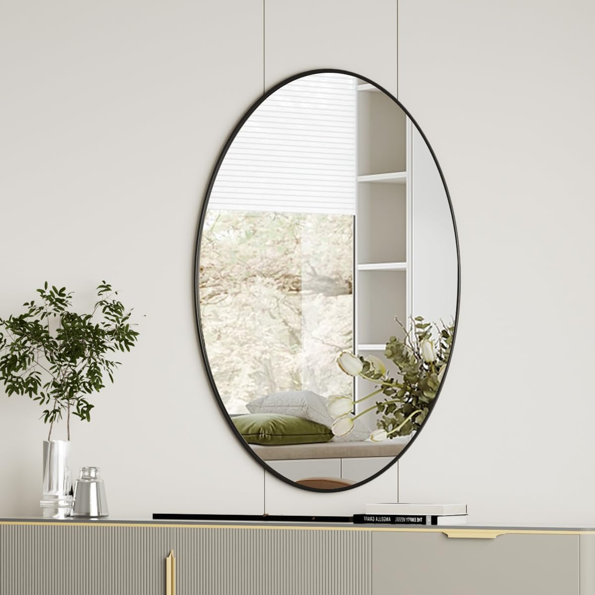 Koonmi black oval mirror front view showing sleek frame and clear reflection