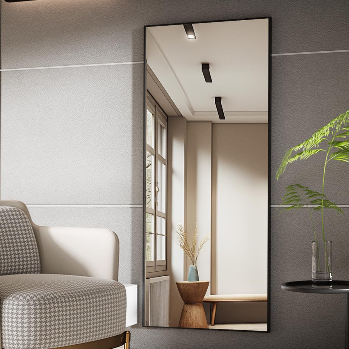 Koonmi mirror with person beside it for accurate size reference
