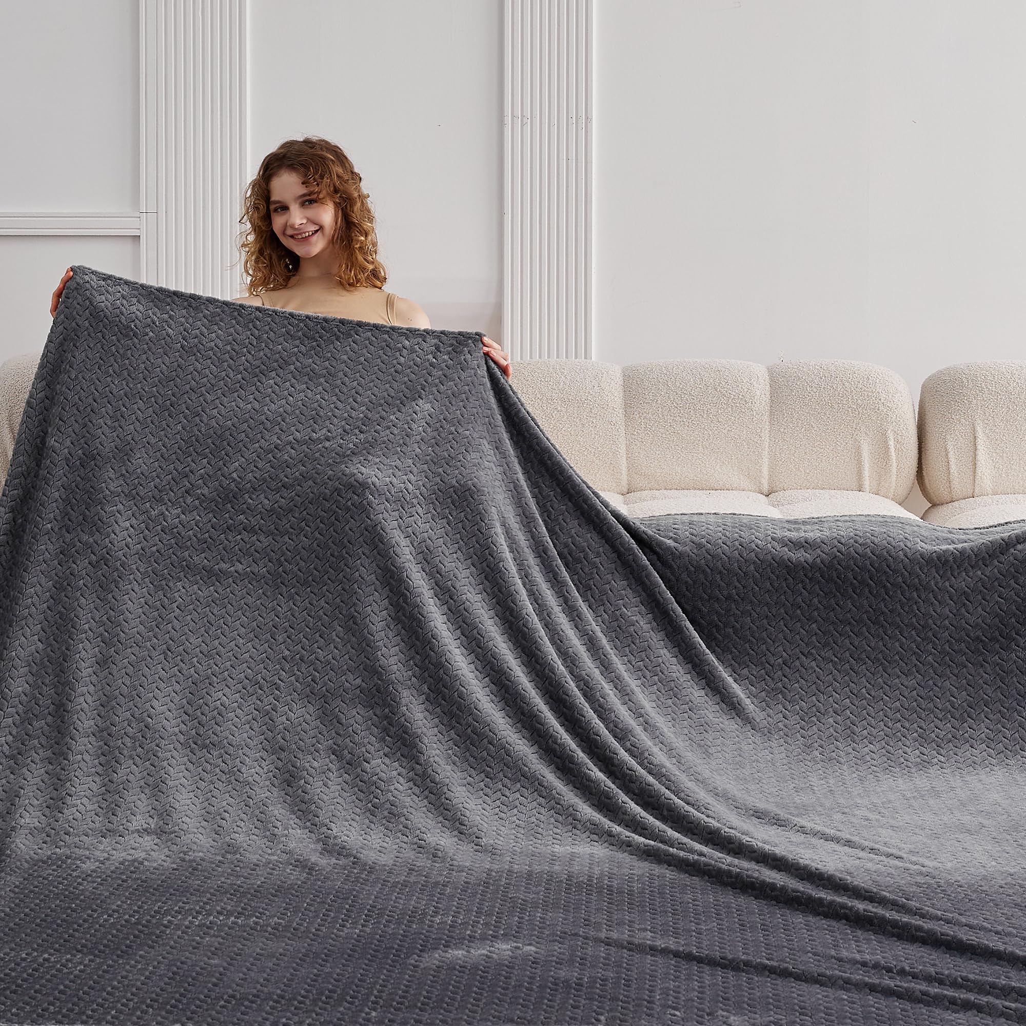 KORBLISS folded on sofa lifestyle showing neat storage and cozy living benefit