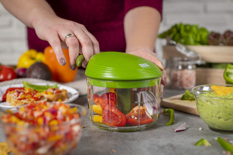Kuhn Rikon bowl beside a 250ml cup demonstrating compact 2-cup capacity