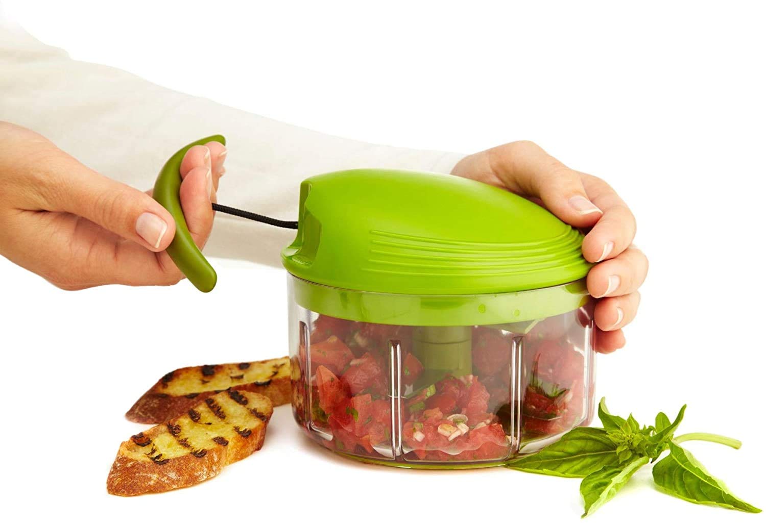 Kuhn Rikon chopping fresh herbs in bowl for fast prep