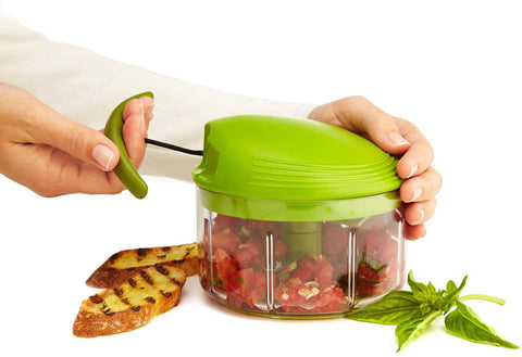 Kuhn Rikon chopping fresh herbs in bowl for fast prep