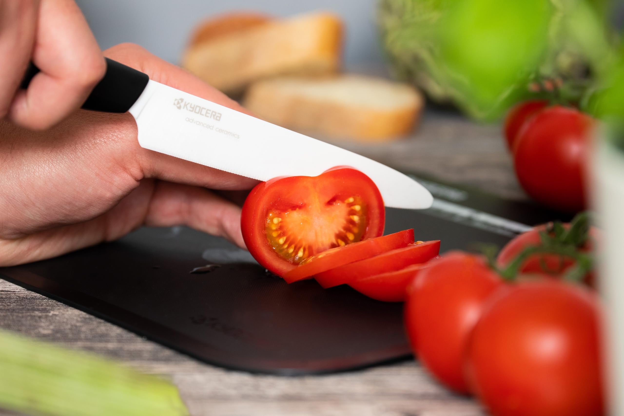 KYOCERA 5-inch micro-serrated slicing a tomato with clean cuts