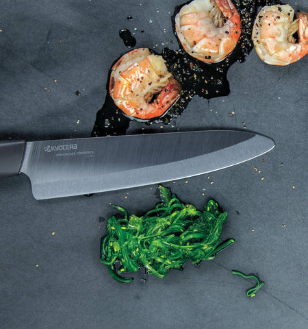 KYOCERA knives arranged on cutting board showing clean cuts and food presentation