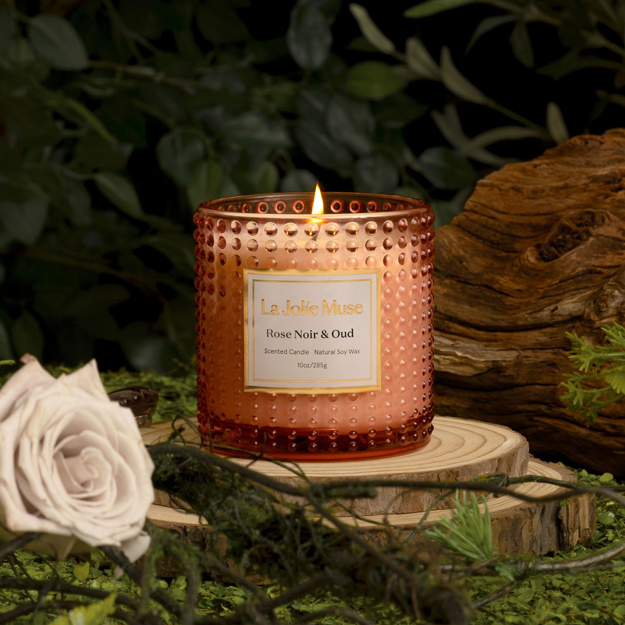 LA JOLIE MUSE lit candle in living room creating warm cozy atmosphere