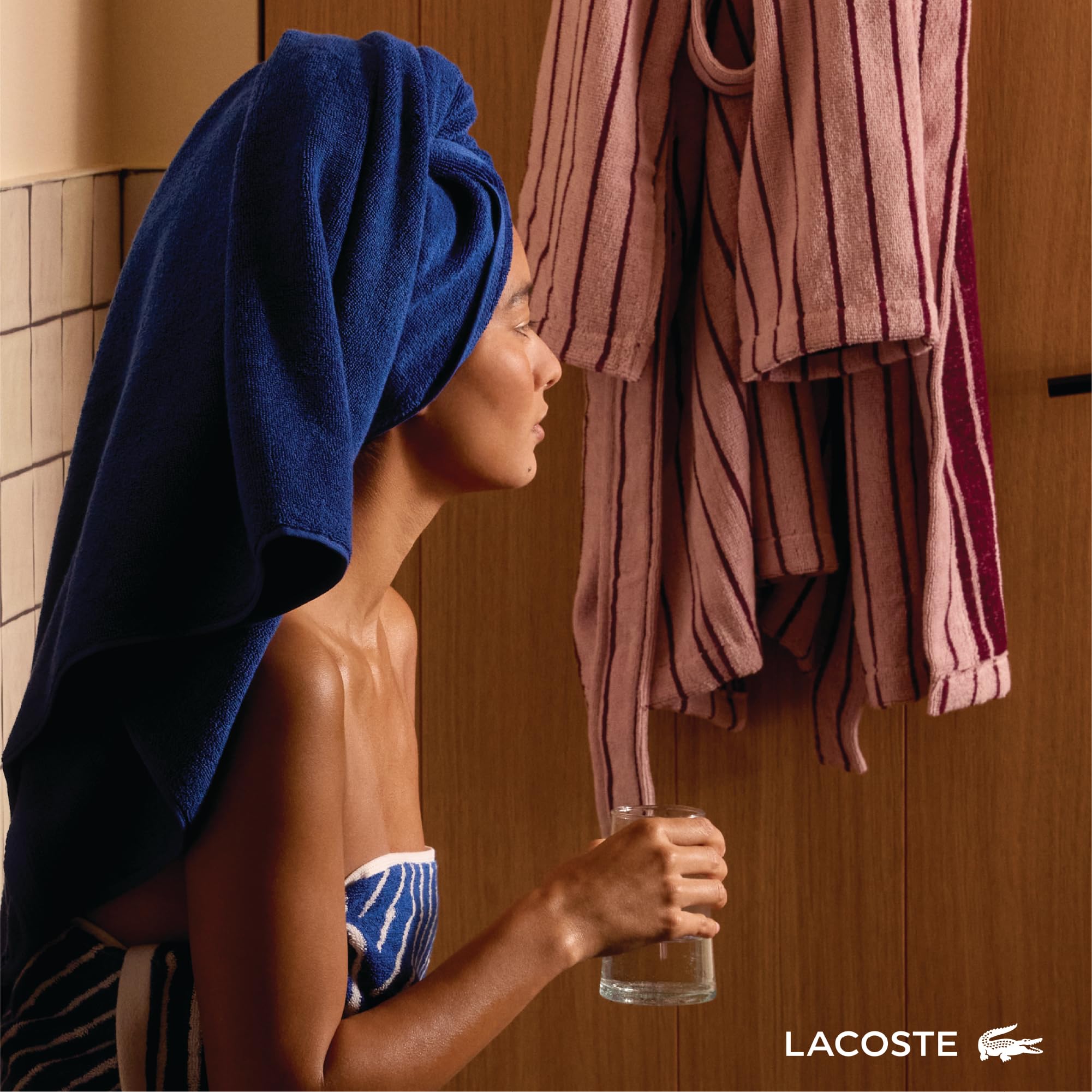 Lacoste towel draped over shoulder in use offering comfortable coverage