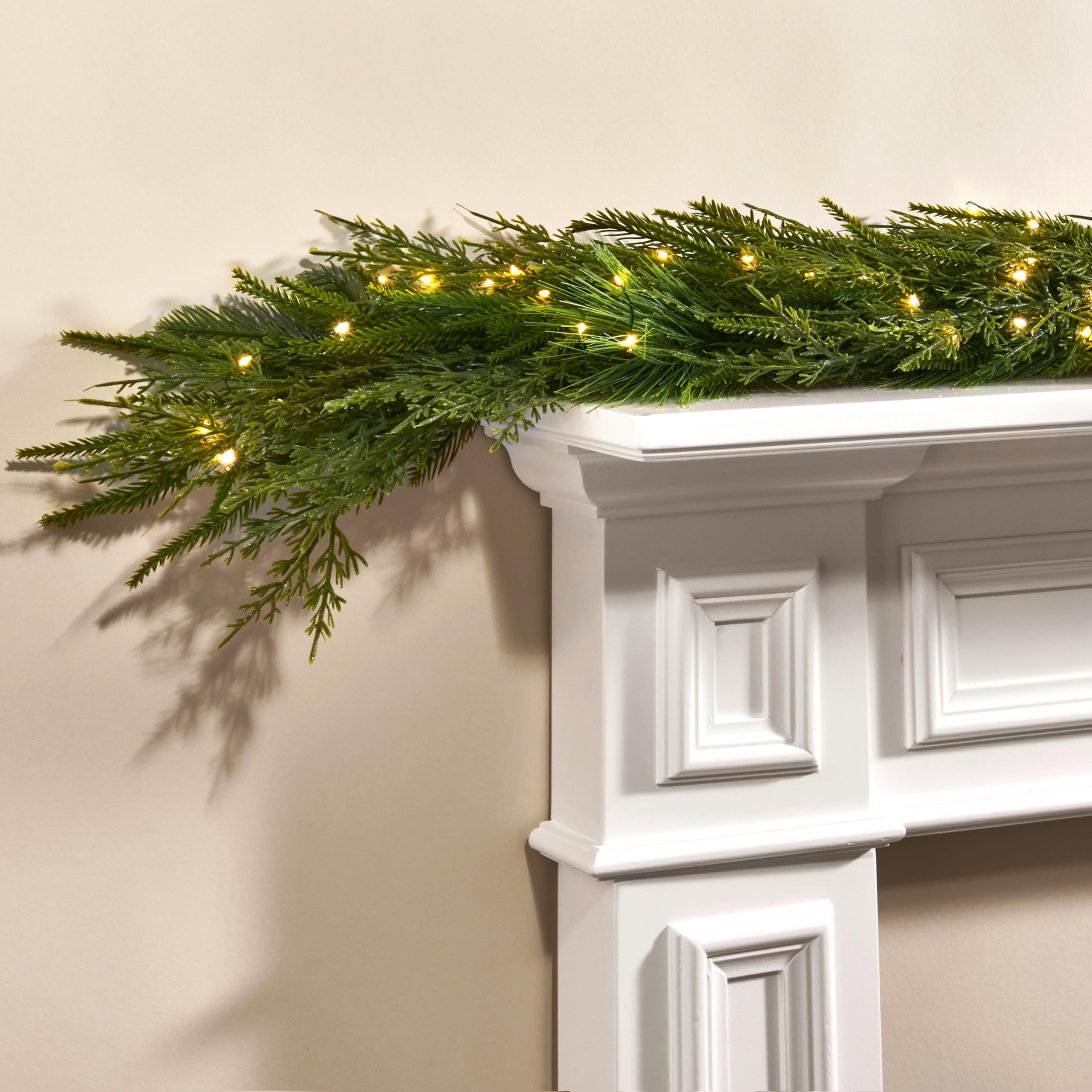 LampLust garland front view showing full lush Norfolk pine greenery and warm ambiance