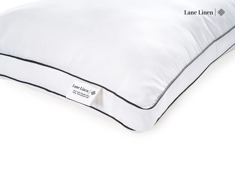 LANE LINEN two pillows styled on made bed showing hotel-like loft and comfort