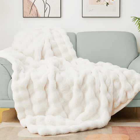 Latepis folded on sofa showing plush beige finish and cozy appeal