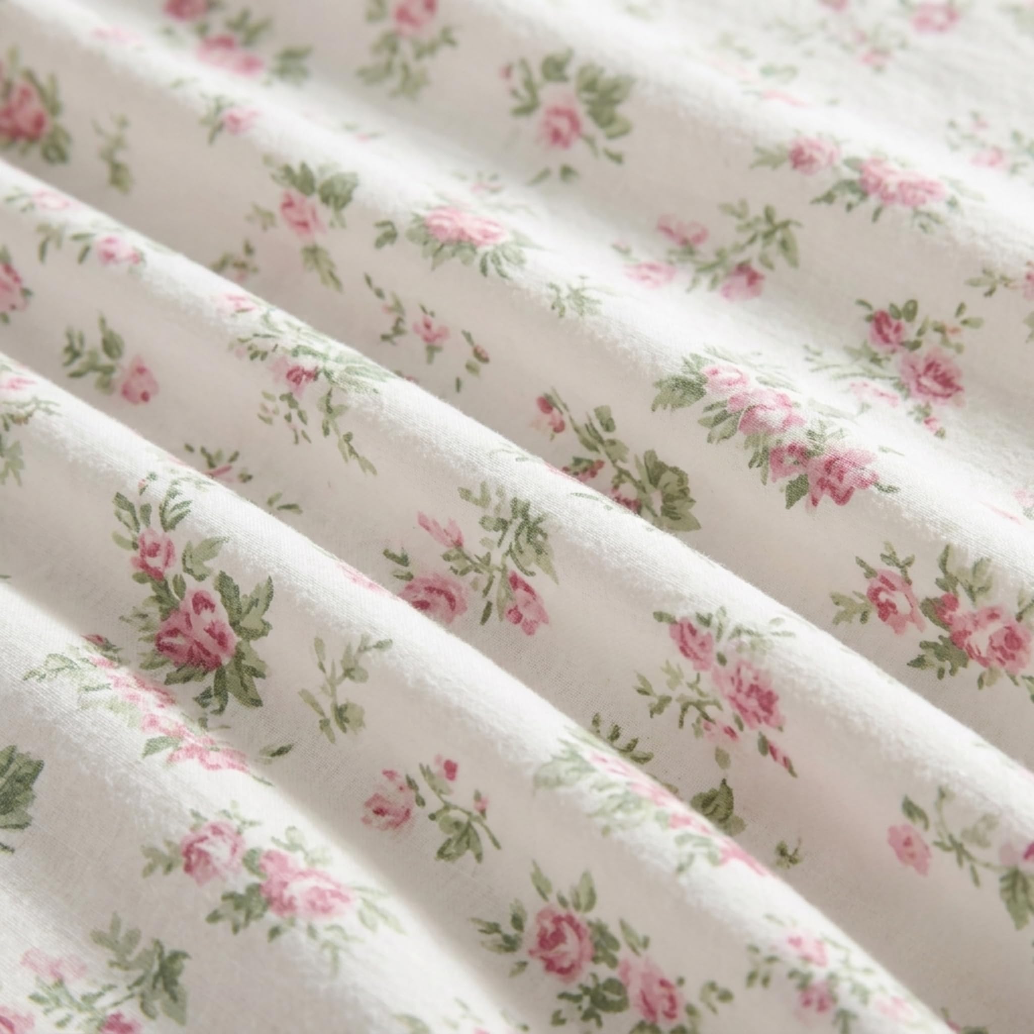 Laura Ashley folded pillowcase and flat sheet displaying coordinated color and finish