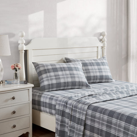Laura Ashley flat sheet spread across bed displaying plaid pattern and cozy drape