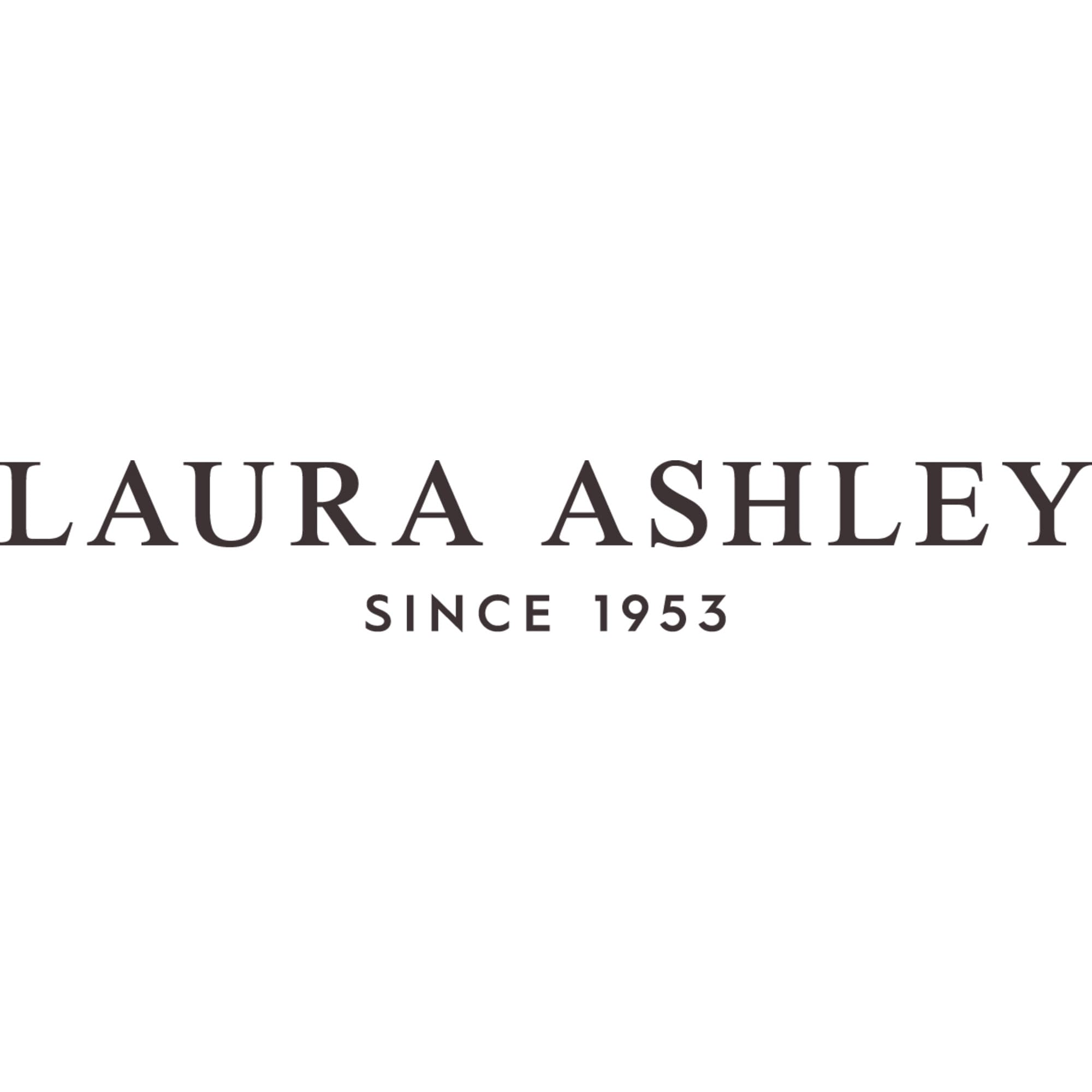Laura Ashley folded bedskirt with label visible showing care instructions and quality