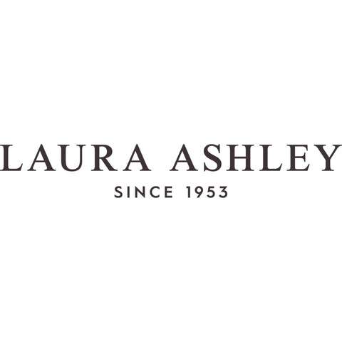 Laura Ashley folded bedskirt with label visible showing care instructions and quality