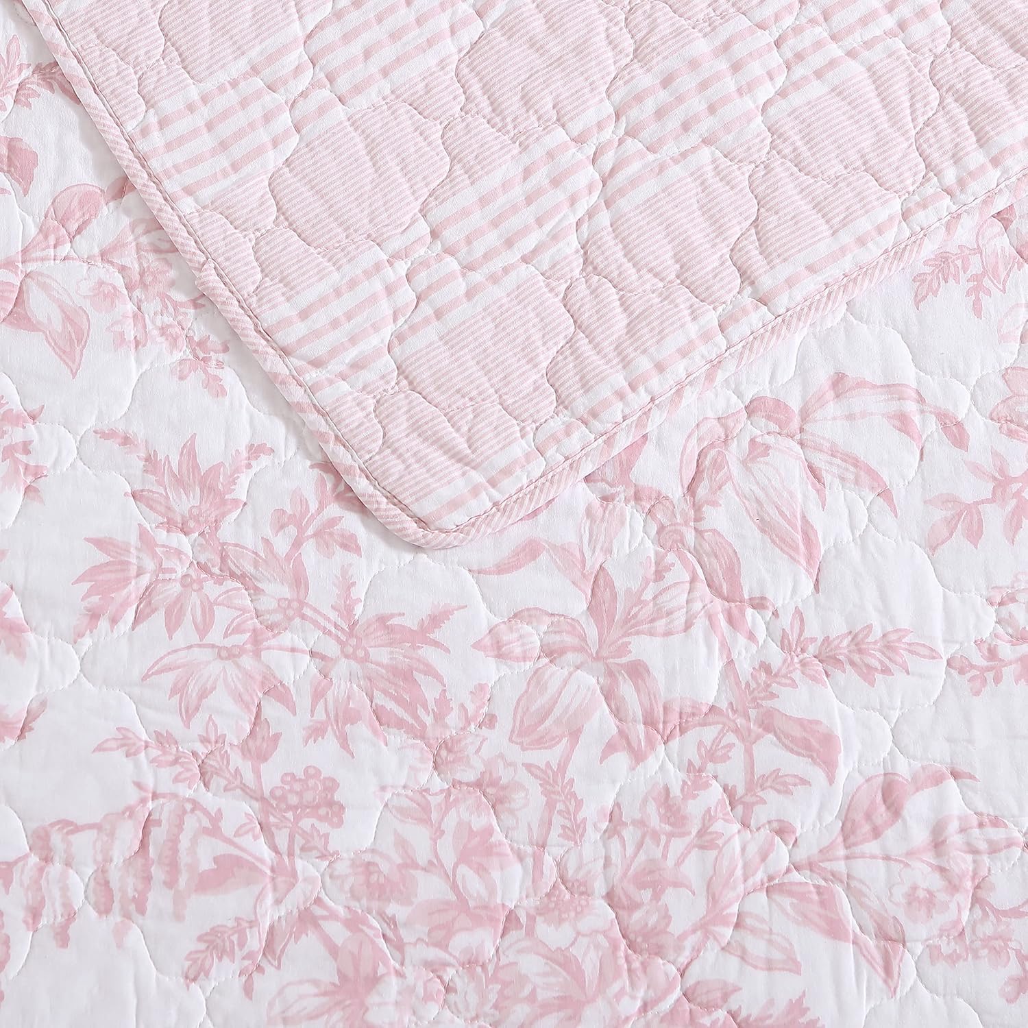 Laura Ashley quilt draped on bed illustrating full/queen coverage and cozy look