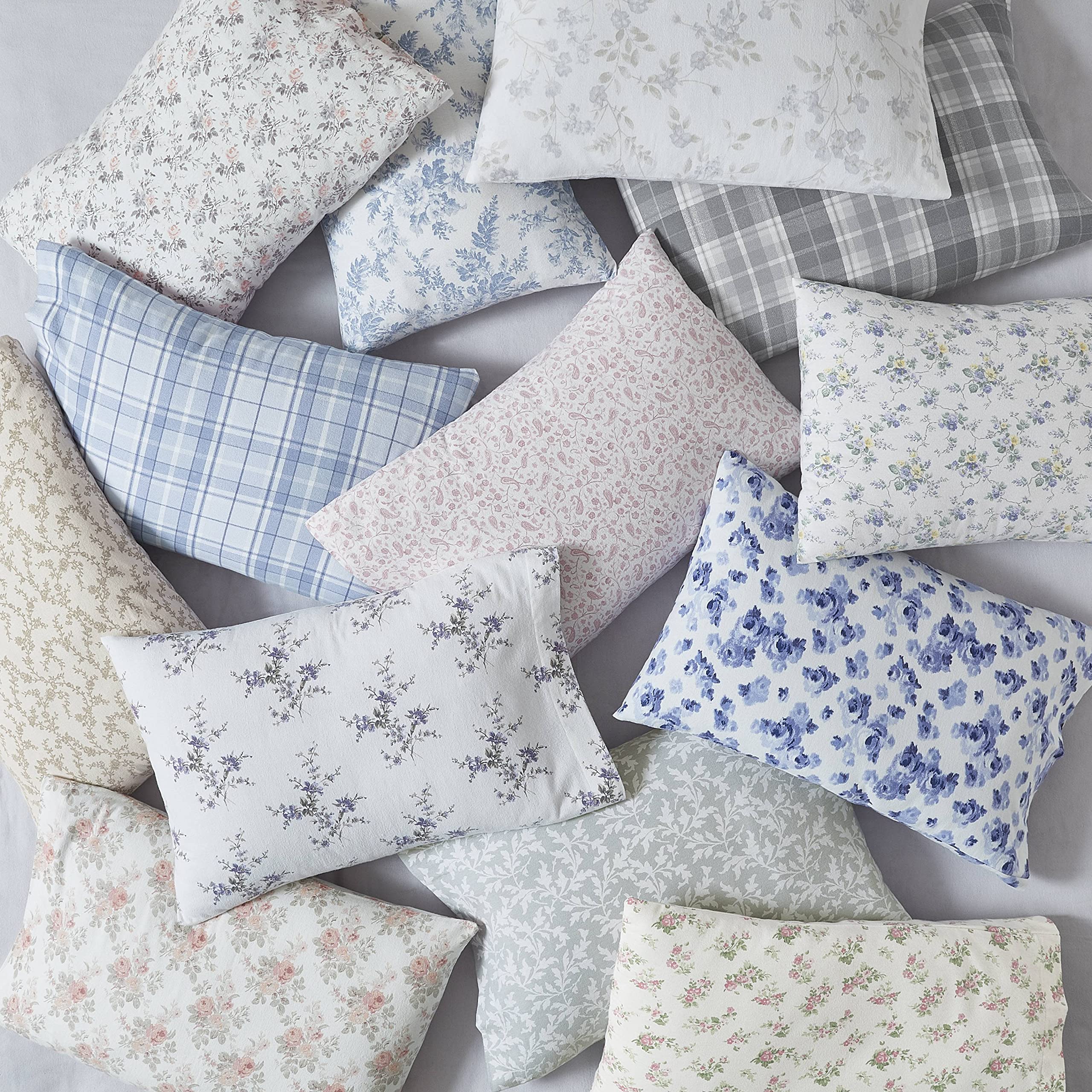 Laura Ashley neatly folded sheets in linen closet for organized storage and freshness