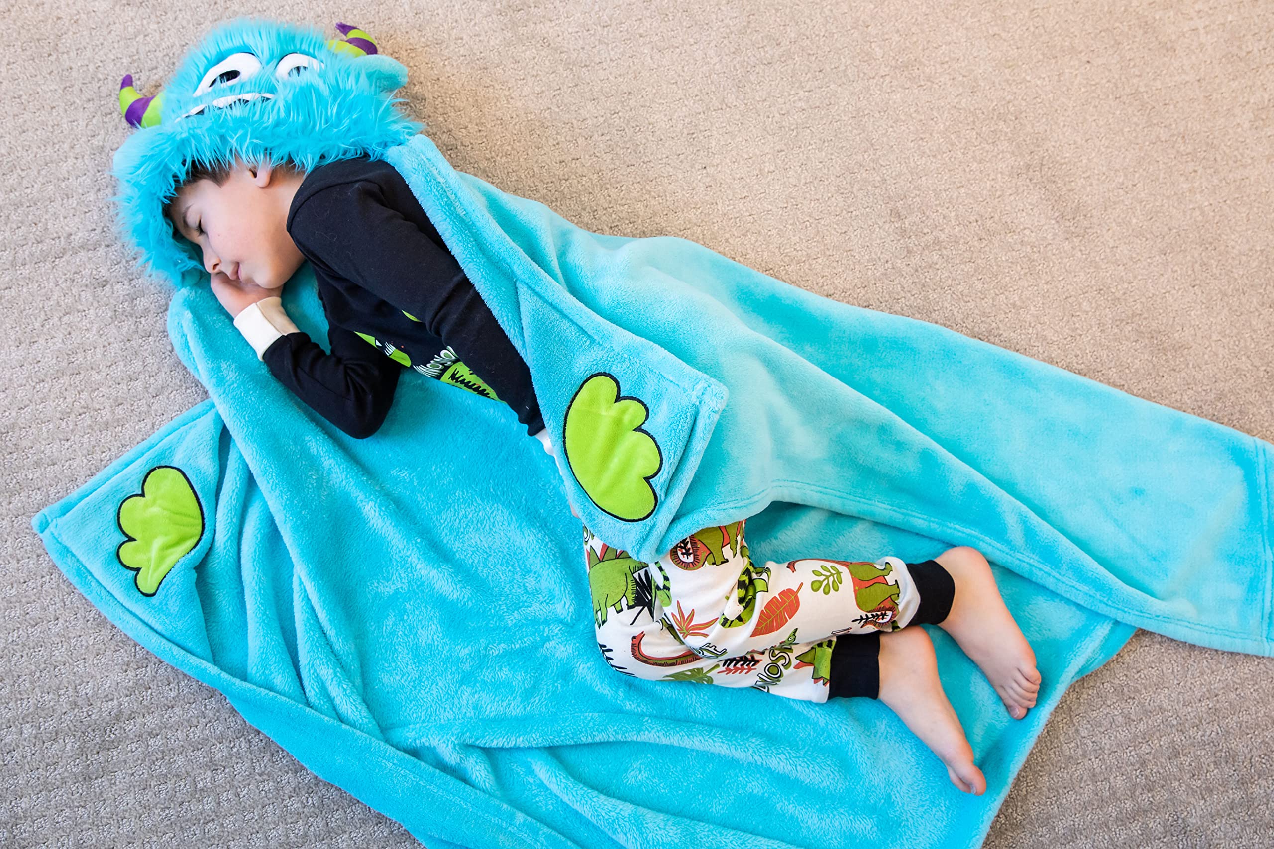 Lazy One child wearing blanket showing movement-friendly fit and imaginative play