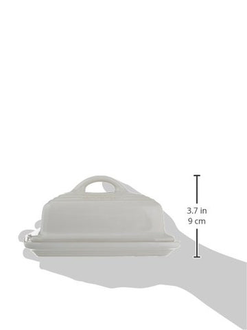Le Creuset butter dish beside butter sticks to show two-stick capacity benefit