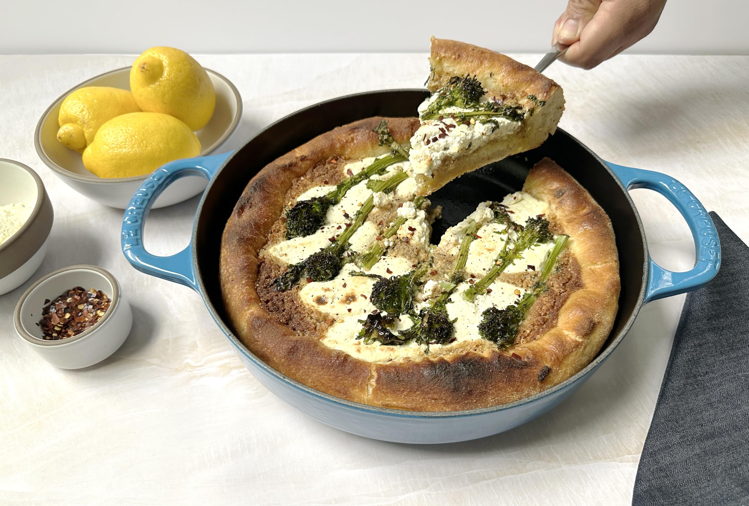 Le Creuset pan beside a spatula showing 11-inch scale for adequate family portions benefit