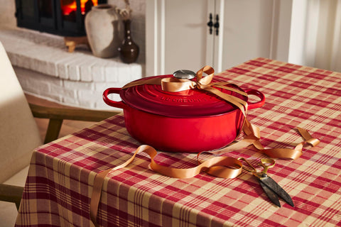 Le Creuset next to measuring cup for scale showing 6.75 qt capacity advantage