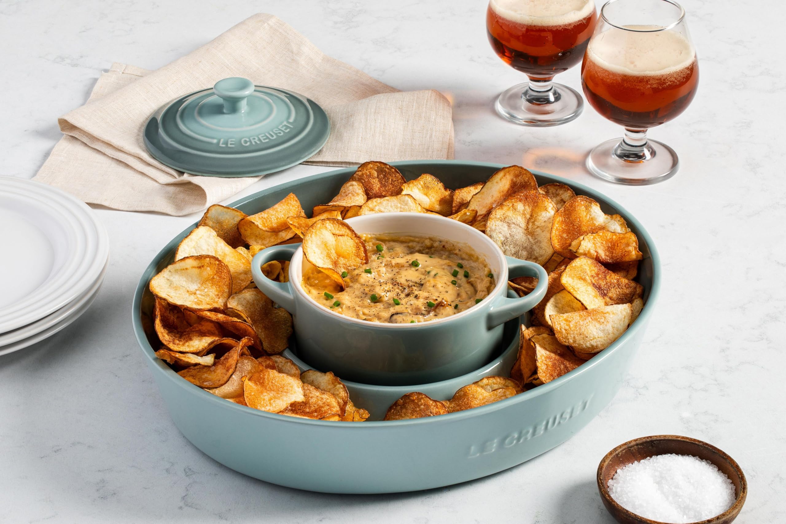 Le Creuset cocotte on table in a styled serving scene enhancing presentation