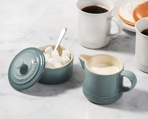 Le Creuset set beside teacup for scale, emphasizing practical, compact footprint