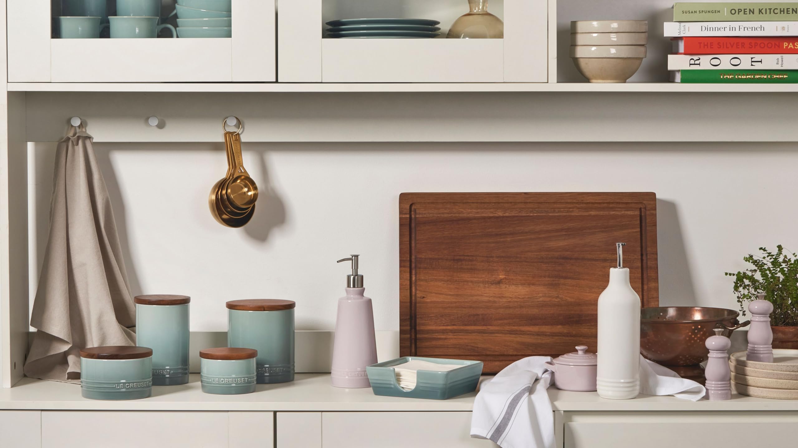 Le Creuset cruet on open shelf with cookware showing cohesive kitchen styling benefit