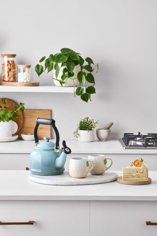 Le Creuset kettle on stovetop in kitchen setting adds color and quick heating