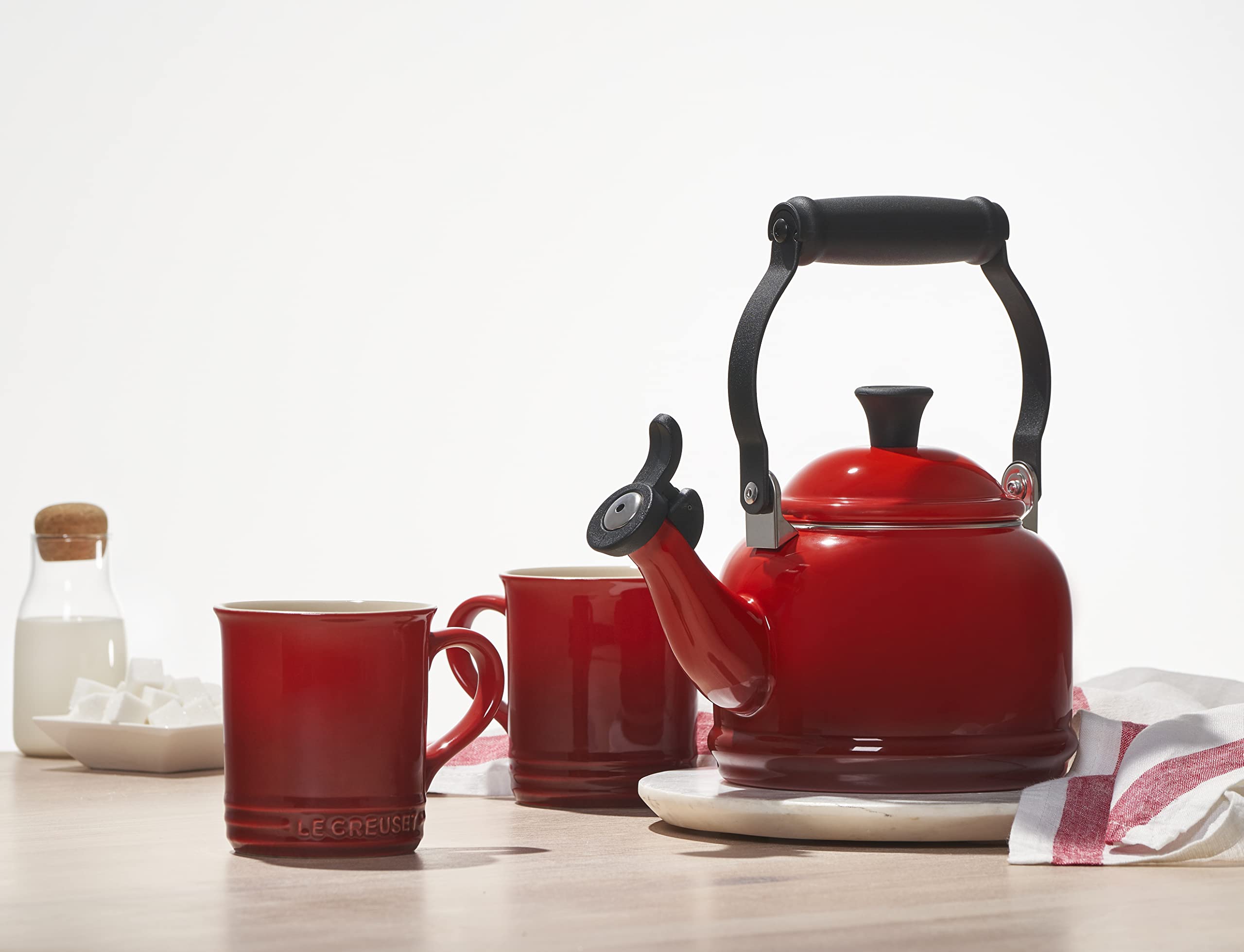 Le Creuset demi kettle on countertop in kitchen setting adding color and function