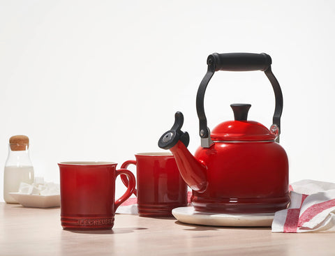 Le Creuset demi kettle on countertop in kitchen setting adding color and function