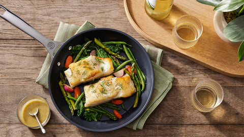Le Creuset frying pan in use sautéing vegetables demonstrating even browning and food release