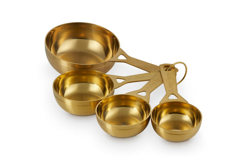 Le Creuset gold measuring cups front view showing polished finish and accuracy