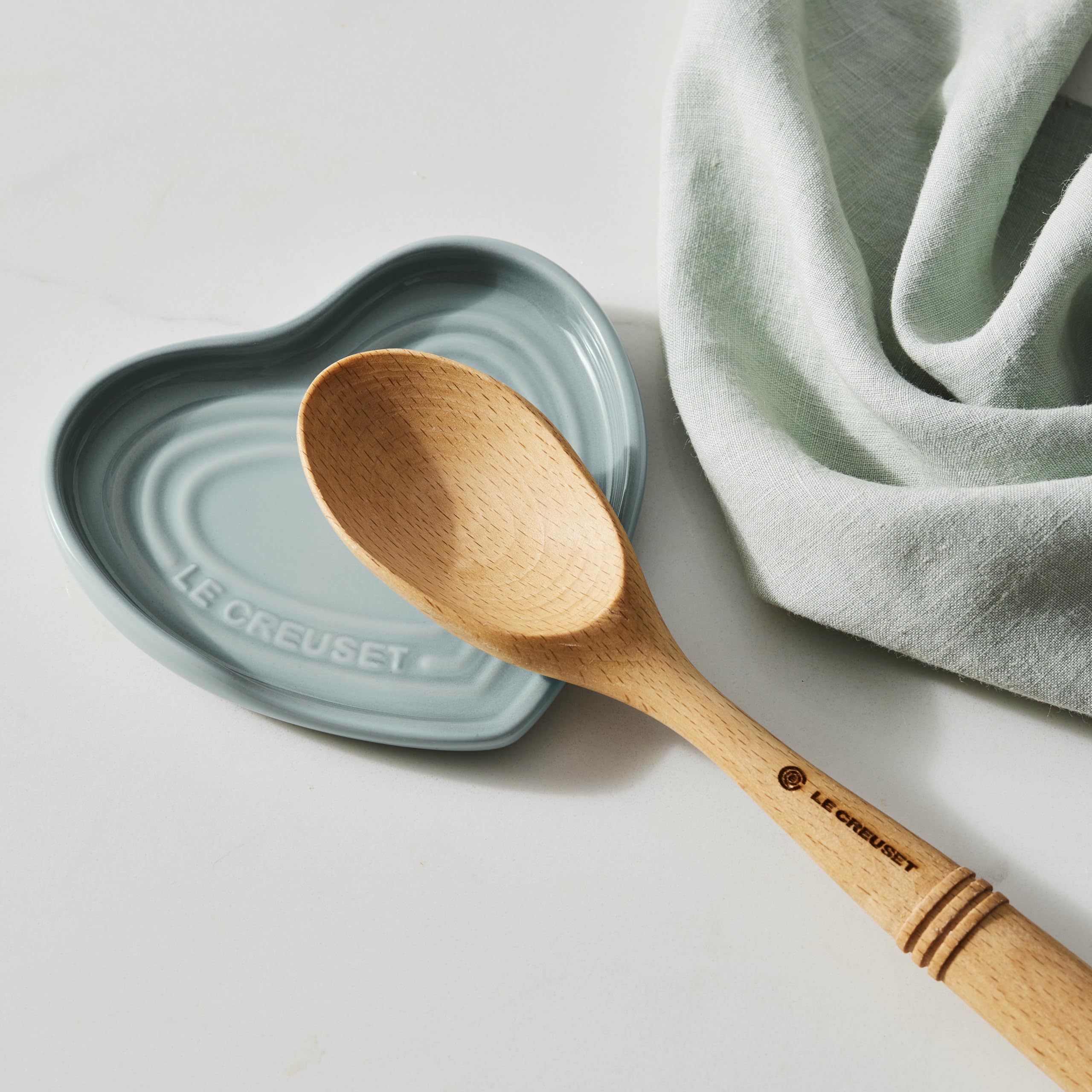 Le Creuset spoon rest next to a ruler showing 5-inch size and compact convenience benefit