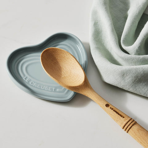 Le Creuset spoon rest next to a ruler showing 5-inch size and compact convenience benefit