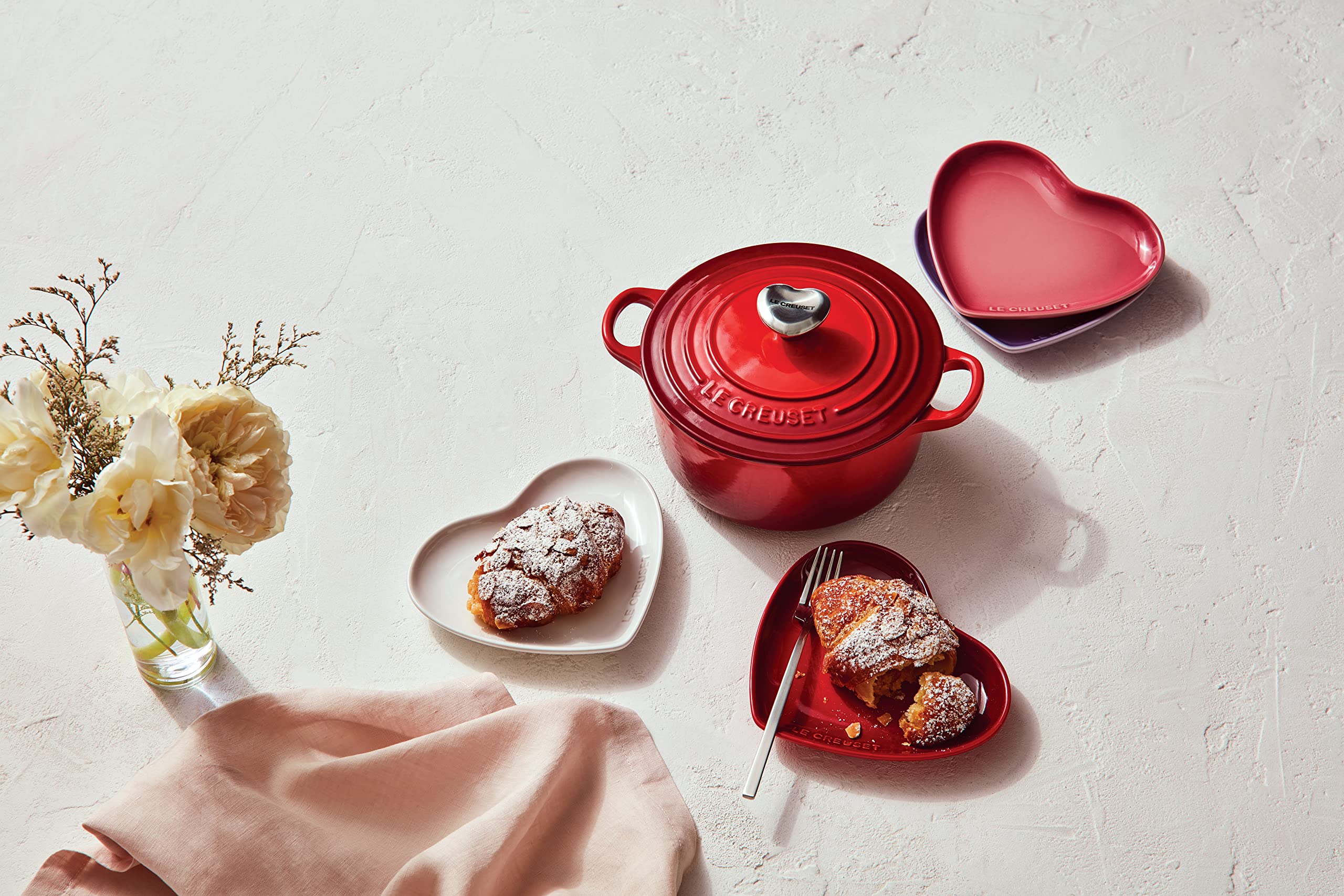 Le Creuset spoon rest holding a wooden spoon demonstrating drip containment benefit
