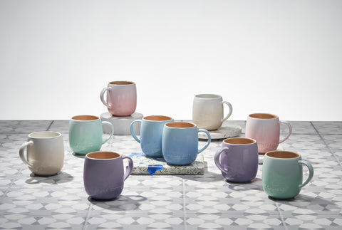 Le Creuset mug in use with coffee highlighting heat retention and style