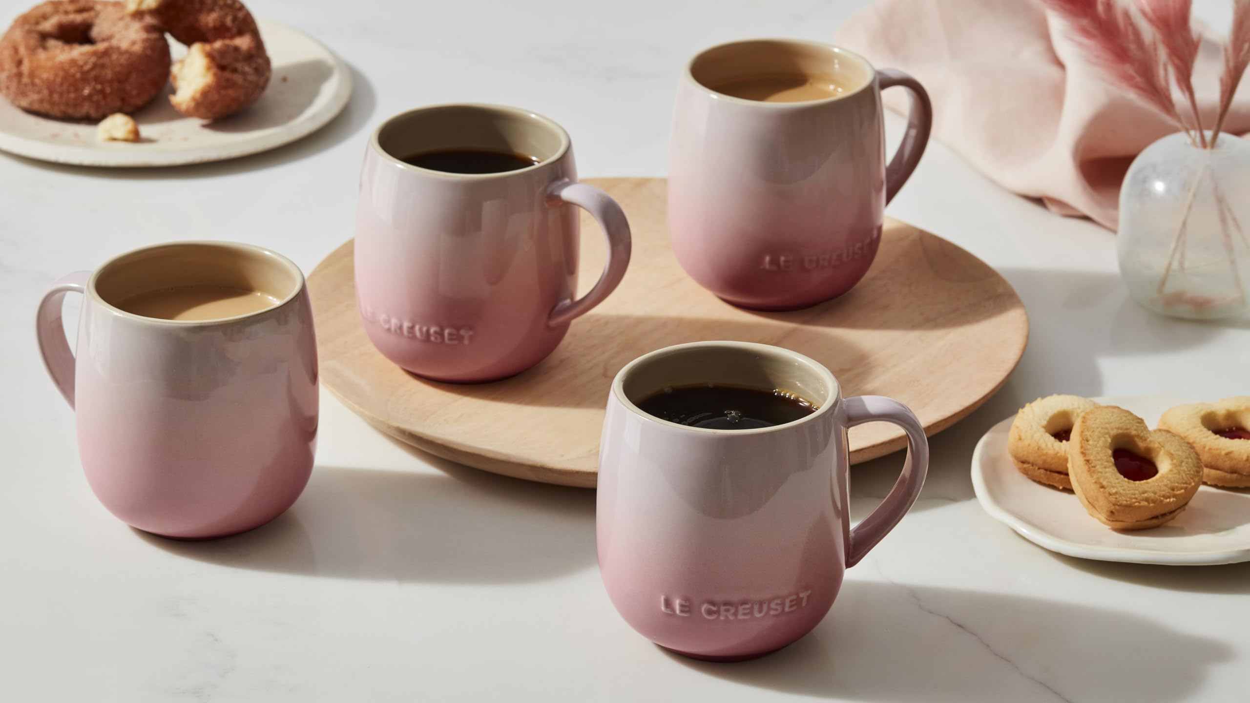Le Creuset mug held in hand to show 13 oz size and practical scale