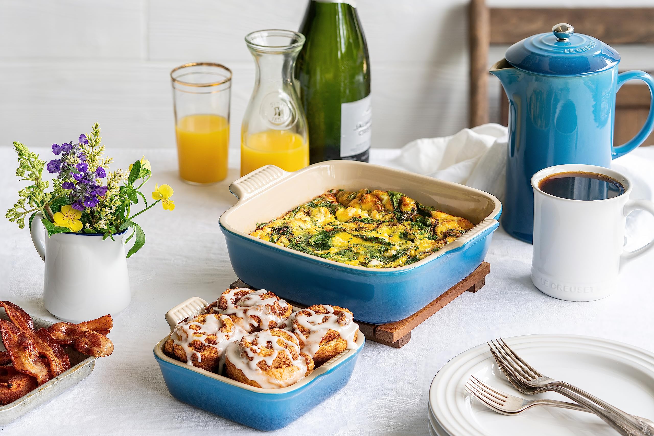 Le Creuset dish in use on table with casserole showing serving-ready presentation and heat retention