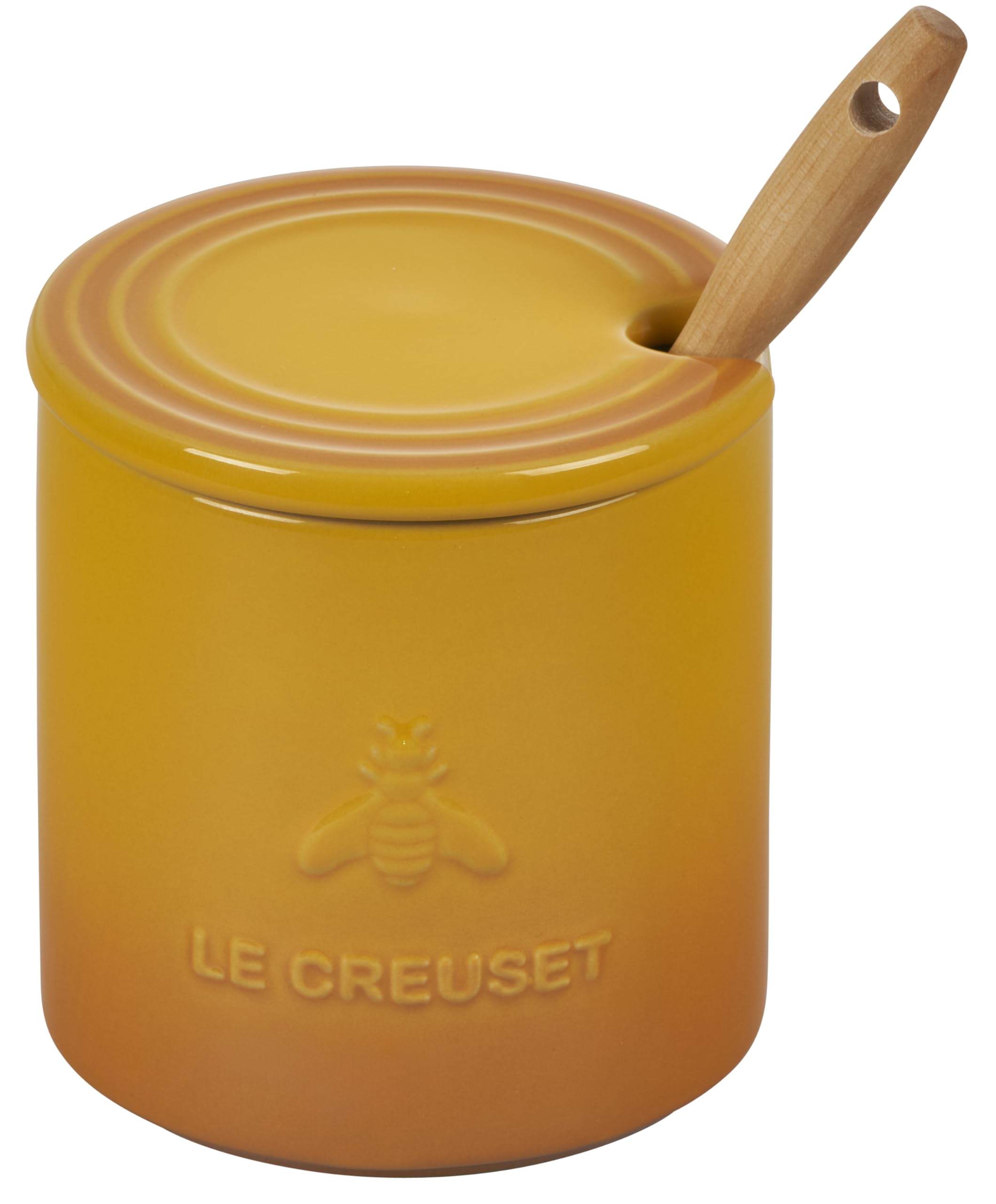 Le Creuset honey pot in use drizzling honey over yogurt for convenience