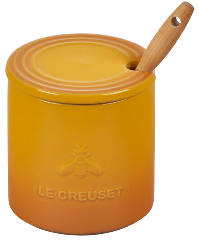 Le Creuset honey pot in use drizzling honey over yogurt for convenience