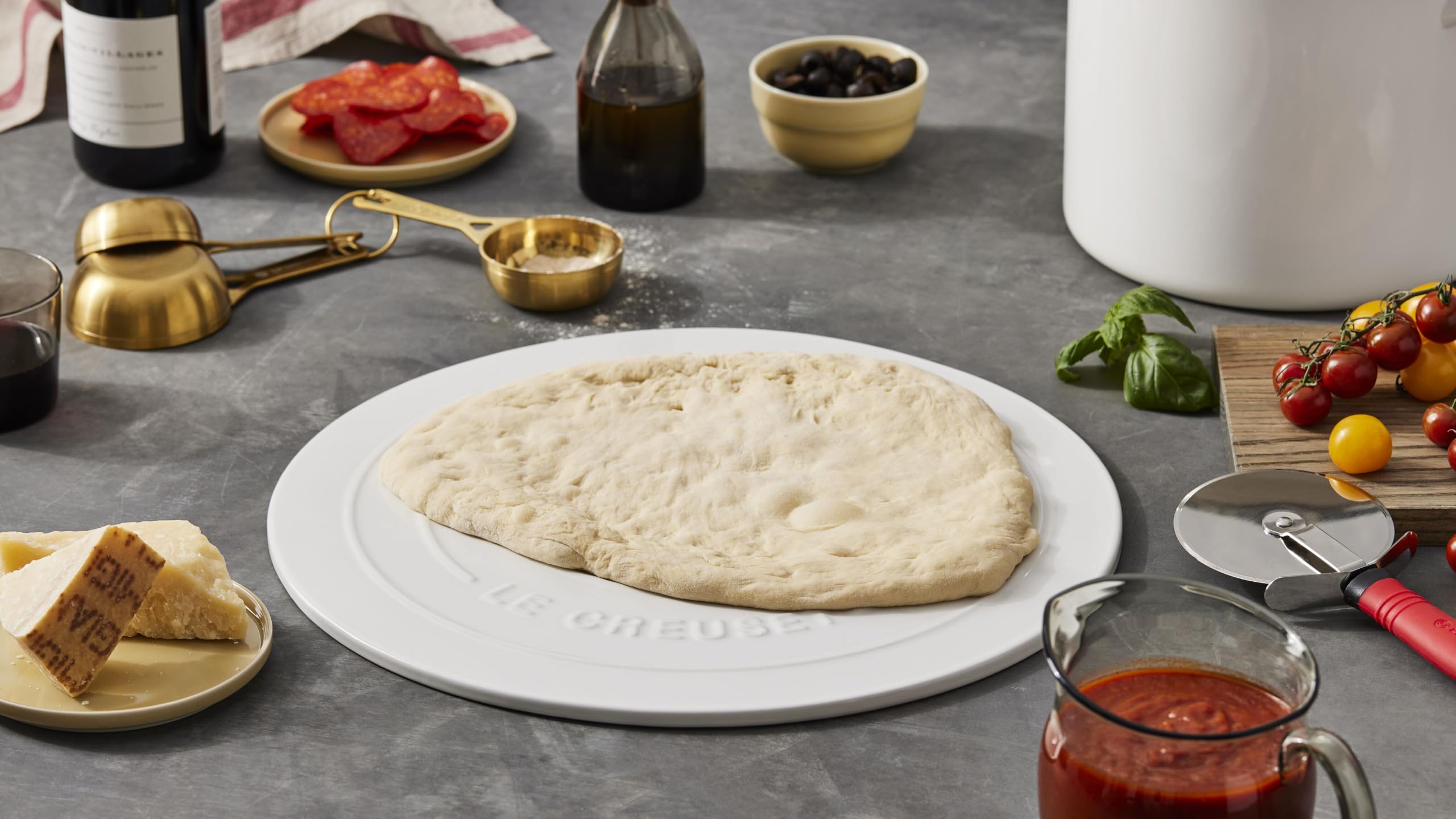 Le Creuset measuring cup pouring batter easily illustrating controlled transfer and neatness